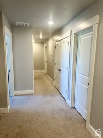 Recessed ceiling lighting, paneled interior doors, and carpeted flooring