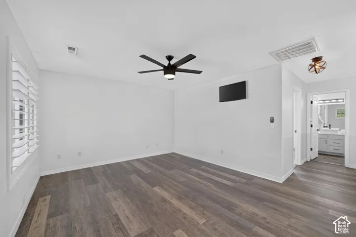 Wood-finish flooring throughout, complemented by a contemporary black ceiling fan