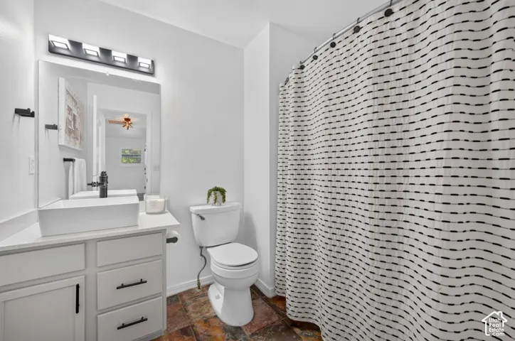 White vanity with a rectangular vessel sink and matte black faucet