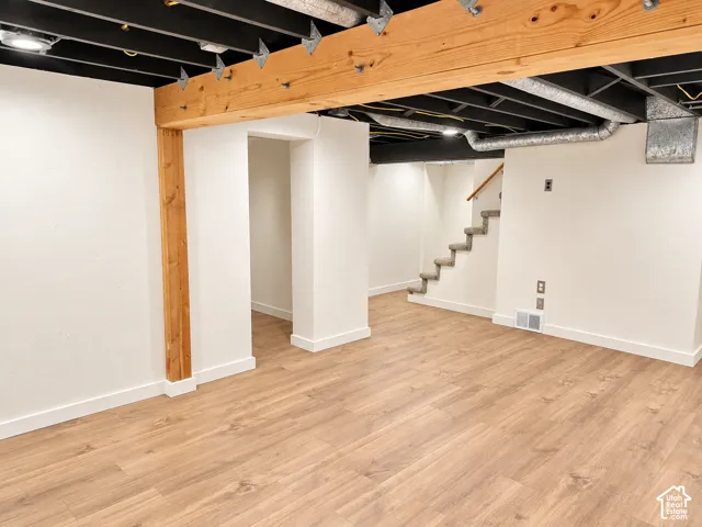 Recessed ceiling lighting, laminate flooring, exposed wooden beams, exposed ceiling joists