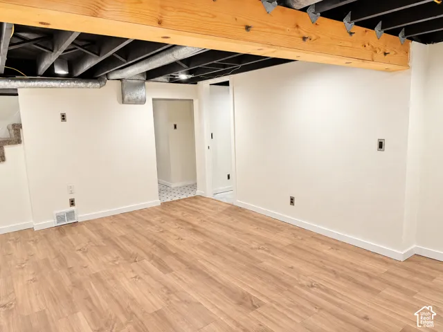 Recessed ceiling lighting, laminate flooring, exposed wooden beams, exposed ceiling joists