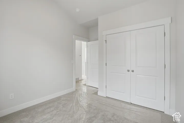 Neutral wall paint, white trim, recessed lighting, and a two-panel closet door