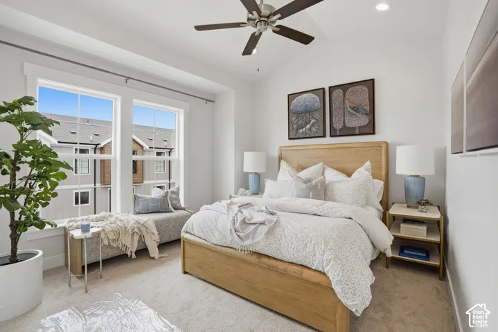 Vaulted ceiling with a ceiling fan, recessed lighting, and large windows with a built-in window bench