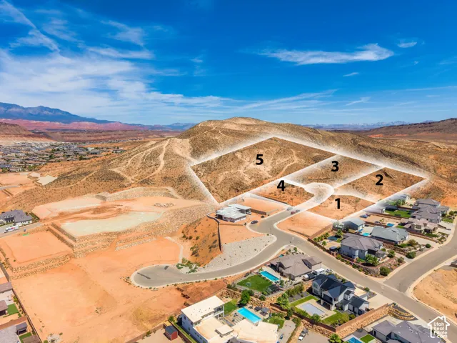 Five building lots available on a hillside, surrounded by existing residential properties and distant mountain ranges