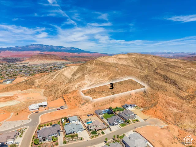 Expansive desert terrain with mountain backdrop