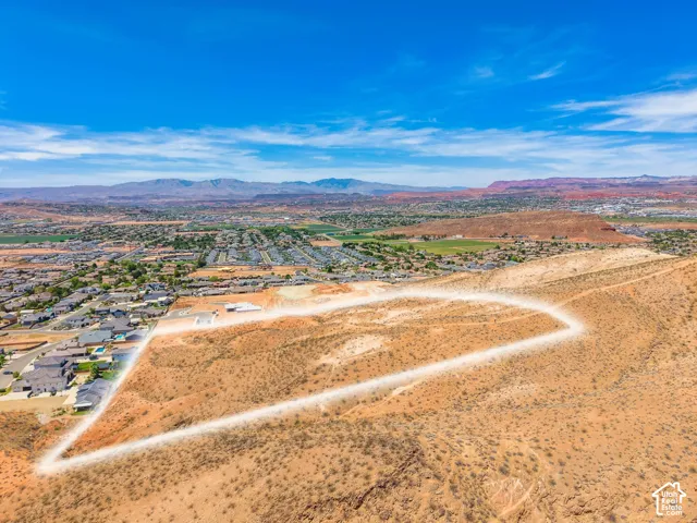 Expansive parcel featuring a natural desert landscape, bordered by residential development