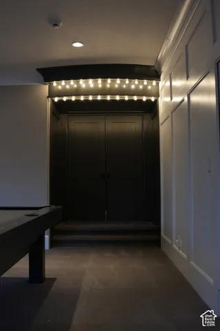 Wall paneling, recessed lighting, carpet flooring, a two-step entry, and double doors