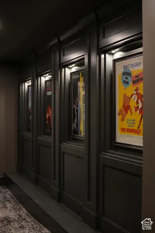 Custom wall paneling with integrated display niches and recessed lighting
