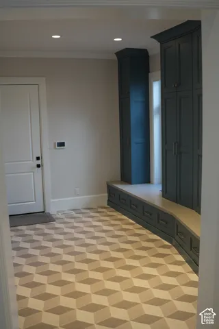Built-in cabinetry with integrated bench seating, recessed lighting, and patterned flooring