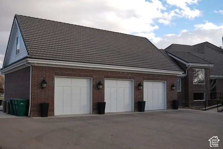 Red brick exterior with a gray tile roof and white gutters