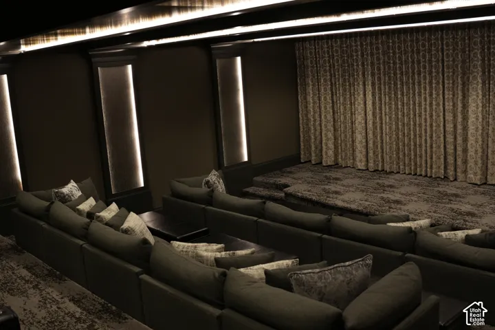 Tiered seating with integrated side tables, illuminated accent panels, and patterned drapery
