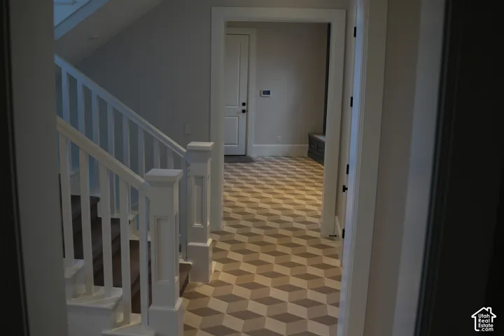 Staircase with white balusters and dark wood treads