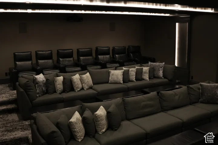 Tiered seating featuring multiple rows of upholstered sofas and individual recliners
