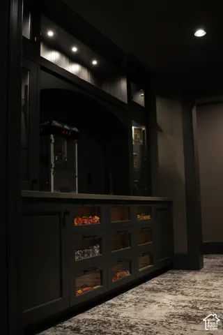 Built-in cabinetry with glass-front drawers, recessed lighting, and an integrated countertop