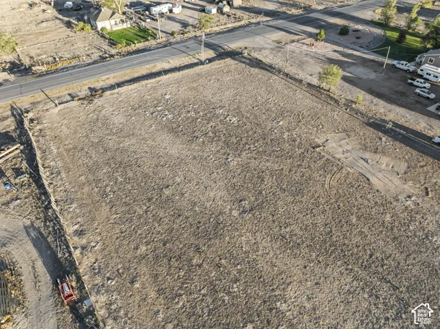 Expansive undeveloped land featuring a perimeter fence and direct road frontage
