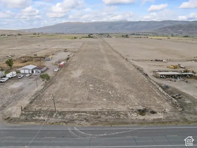 Expansive undeveloped lot with partial fencing and distant mountain scenery