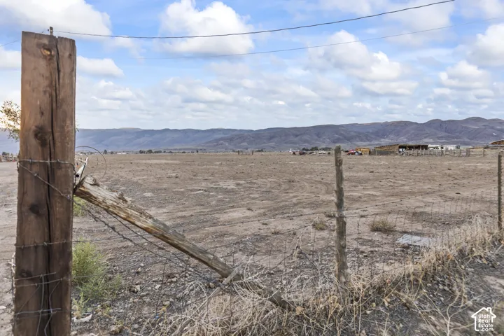 Expansive open lot with distant mountain backdrop