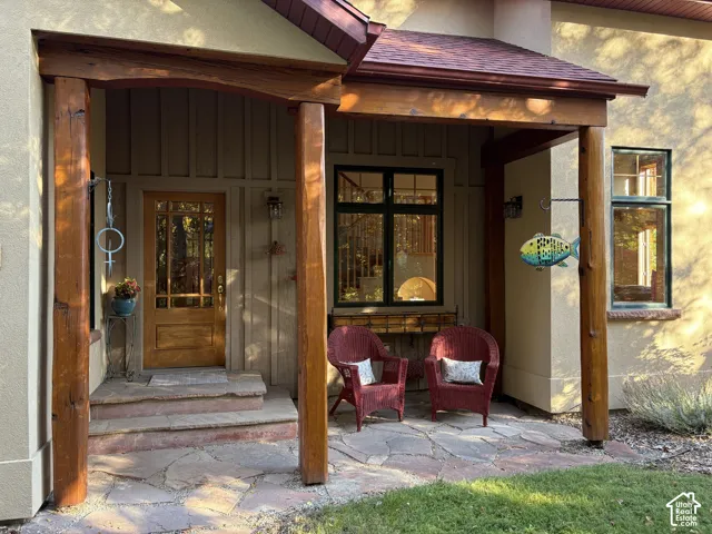 Covered entry featuring wood posts and beam construction