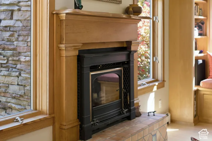 Wood-finish fireplace mantel, tiled hearth, and integrated fireplace insert