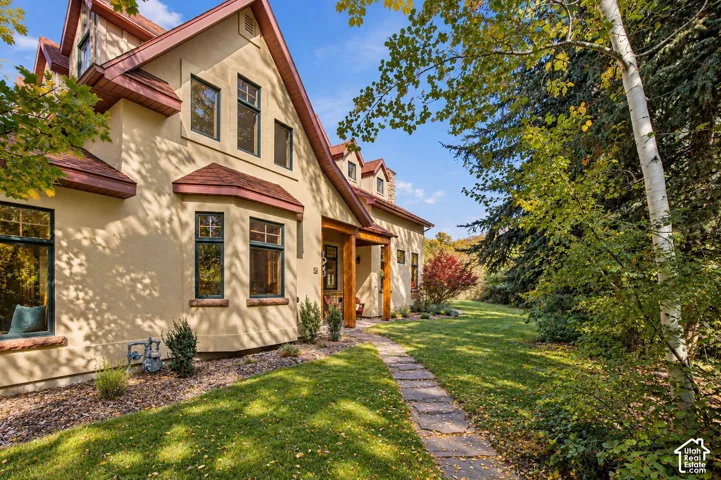Stucco exterior with multiple gables and dormers