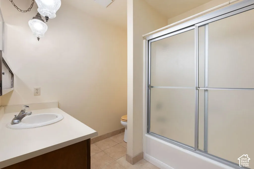 Single vanity with an integrated white sink, chrome faucet, and wood-finish cabinetry