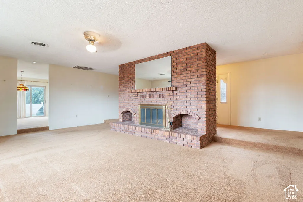 Brick-faced fireplace with a built-in hearth and mirrored mantle