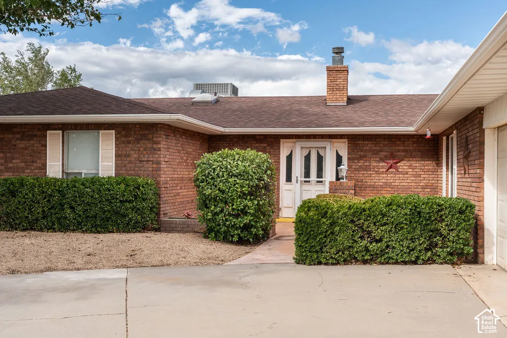 Brick exterior with a brown shingle roof