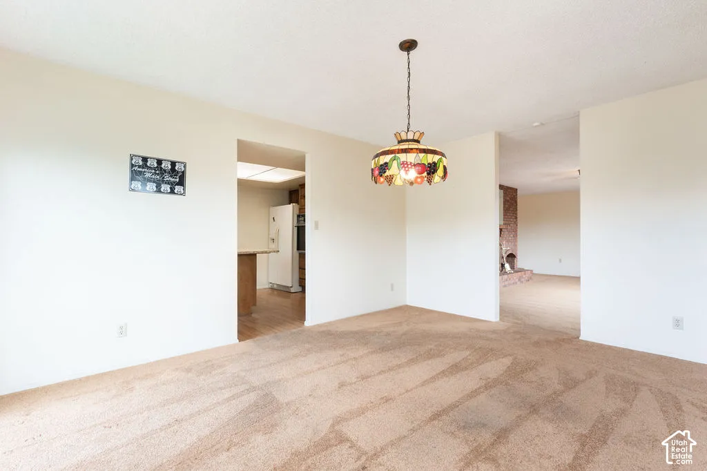 Expansive carpeted area with a ceiling-mounted stained glass light fixture