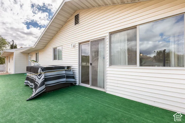Exterior featuring siding, sliding glass door, and large windows