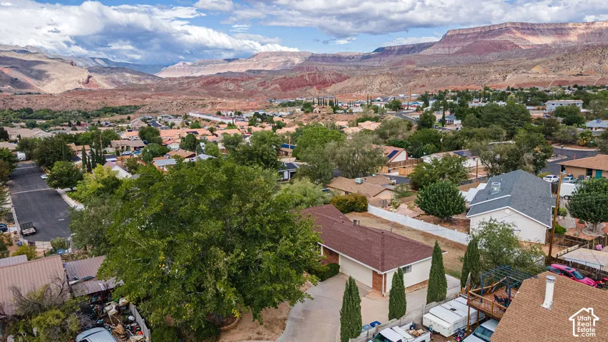 Residential area with mature trees and desert mountain scenery