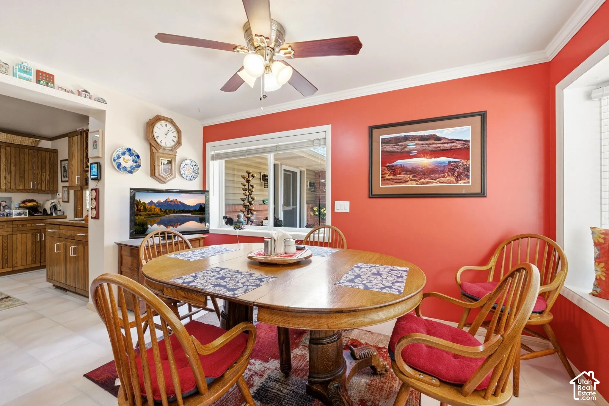 Dining area featuring a ceiling fan, crown molding, and a window with blinds