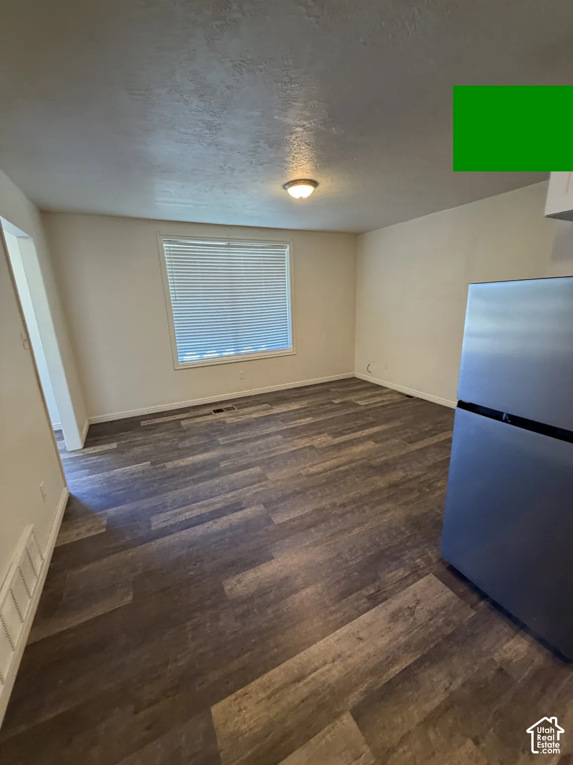 Wood-finish flooring, recessed lighting, and a window with blinds