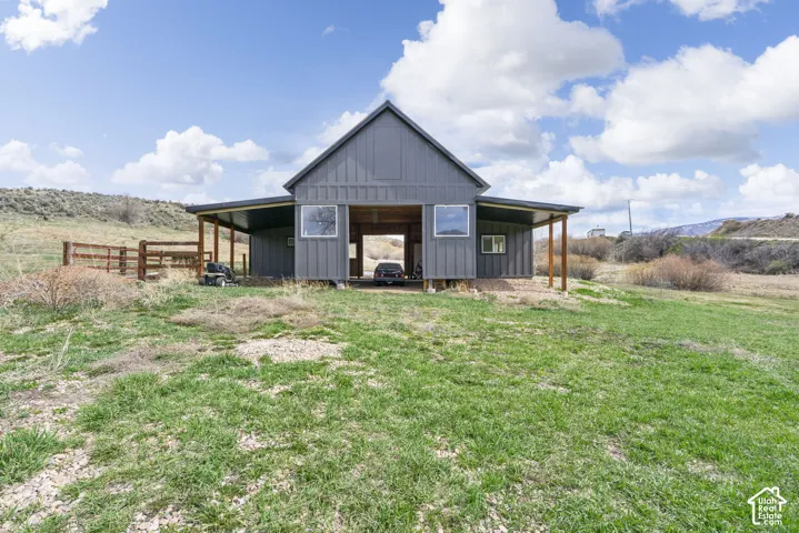 Board and batten exterior with an expansive covered porch, supported by exposed wood columns