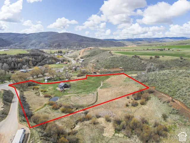 Expansive lot featuring varied topography and a visible pond