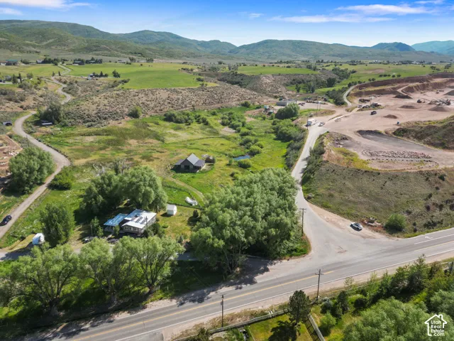 Expansive landscape featuring diverse terrain with rolling hills and distant mountains