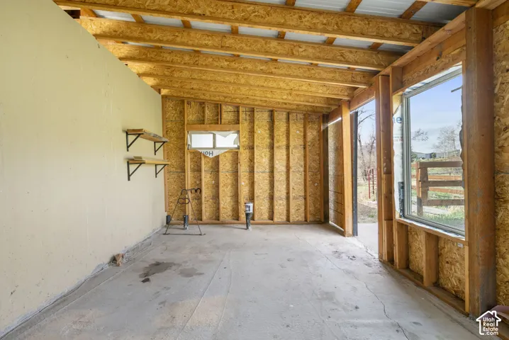 Exposed wood beam ceiling with corrugated metal roofing