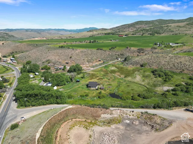 Expansive rural landscape featuring rolling hills and distant mountains