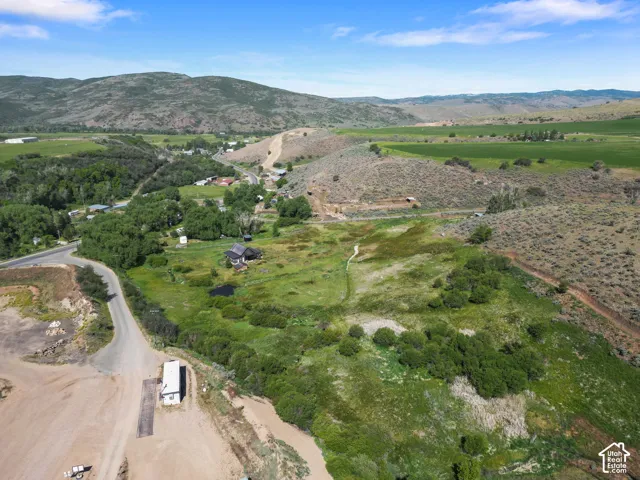 Expansive terrain featuring varied topography, surrounding natural hills, and a diverse mix of trees and open land