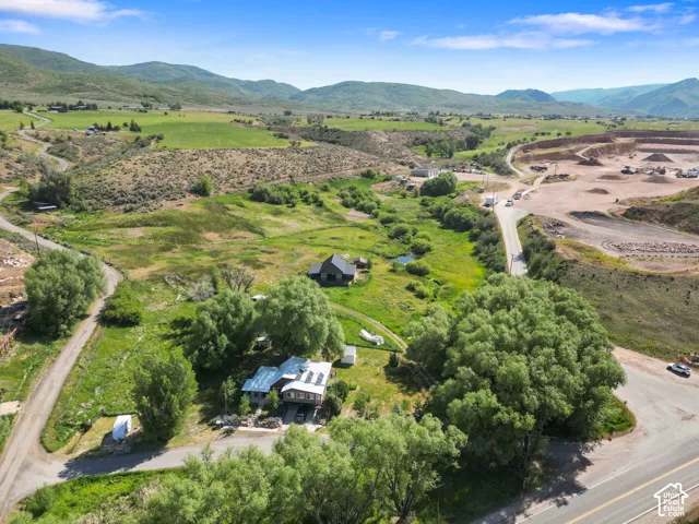 Expansive natural landscape with rolling hills and a winding road