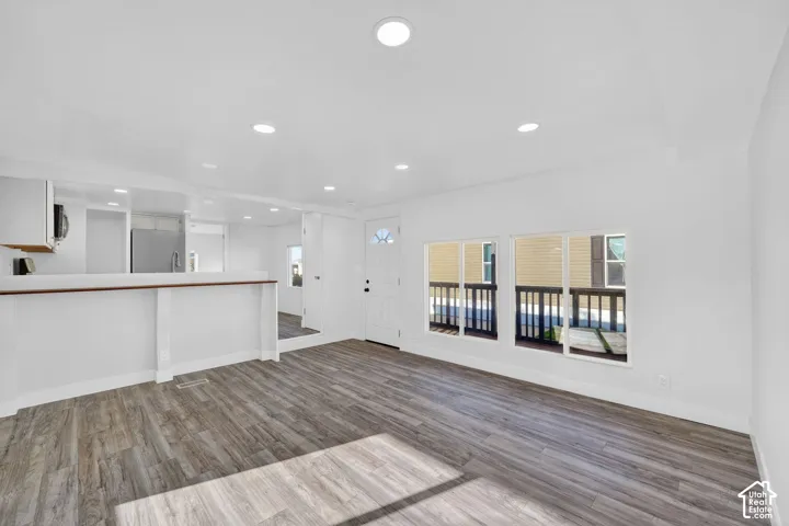 Wood-finish flooring, recessed lighting, and multiple windows
