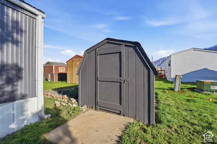 Freestanding storage shed with wood paneling and a dedicated concrete pad