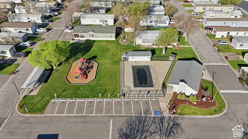 Community amenities featuring a playground, outdoor swimming pool, and dedicated parking spaces