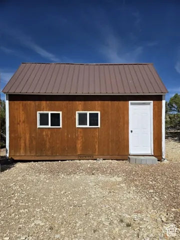 Wood-paneled exterior with a brown metal roof