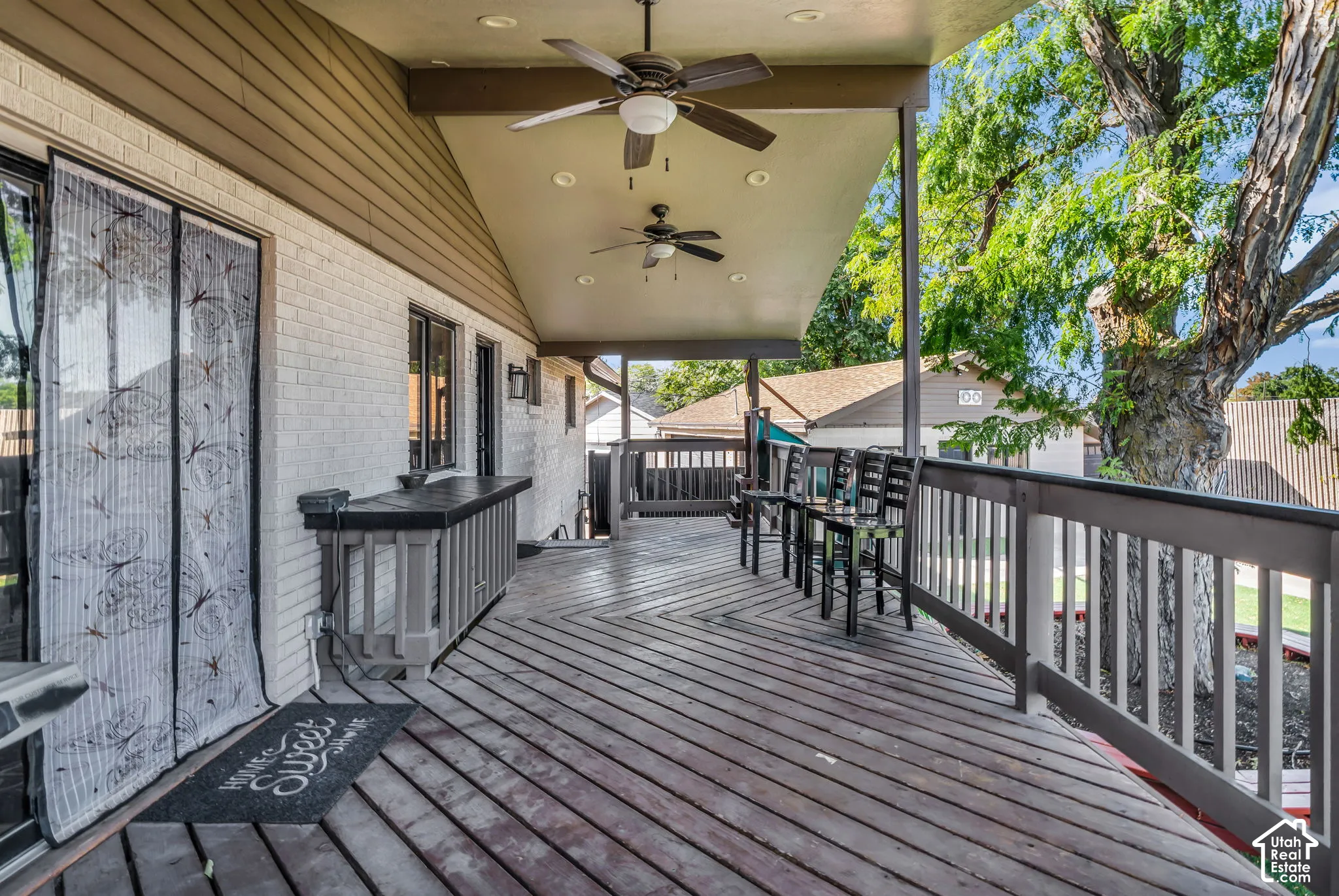 Expansive outdoor deck featuring wood-finish flooring and a built-in counter
