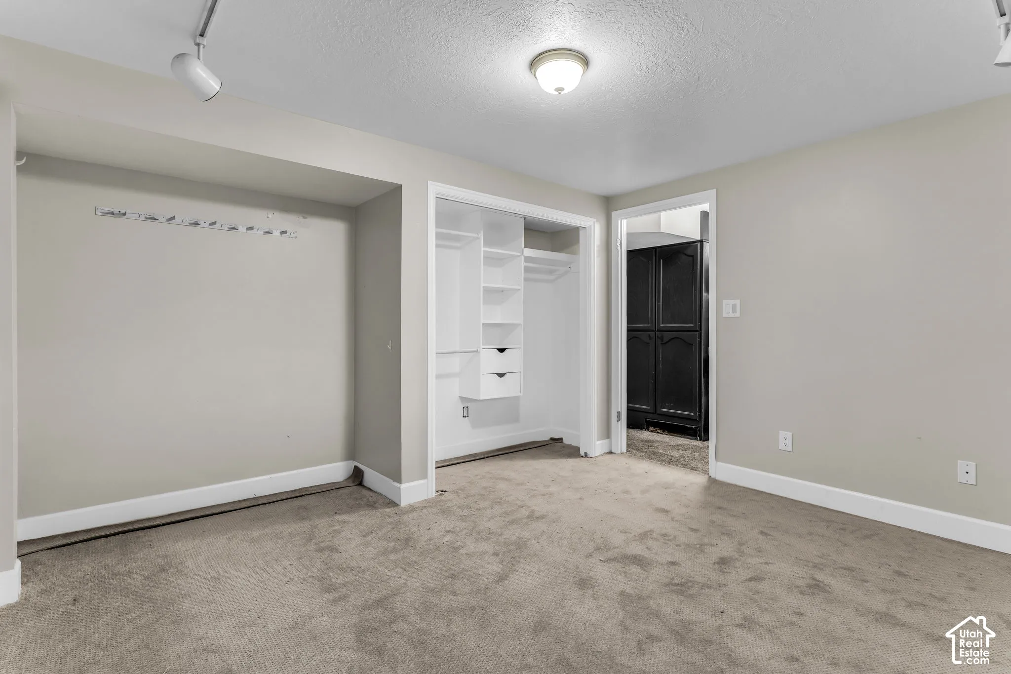 Neutral-toned walls complement the carpeted flooring
