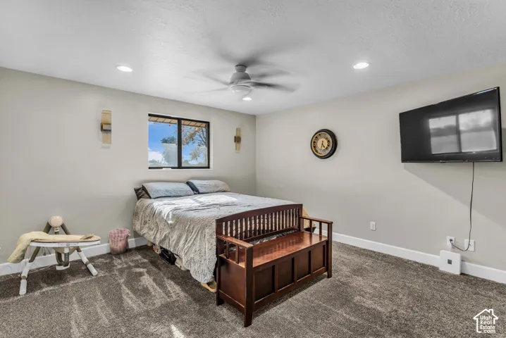 Recessed lighting, ceiling fan, broadloom carpet, and a window with exterior visibility