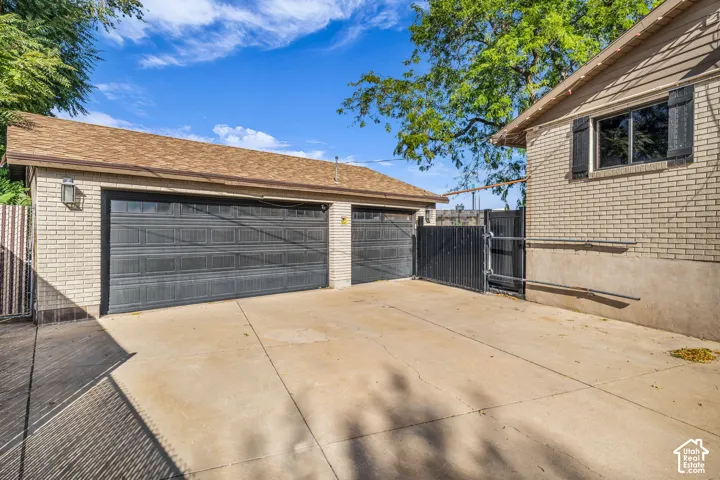 Detached garage featuring dual bay doors and brick construction