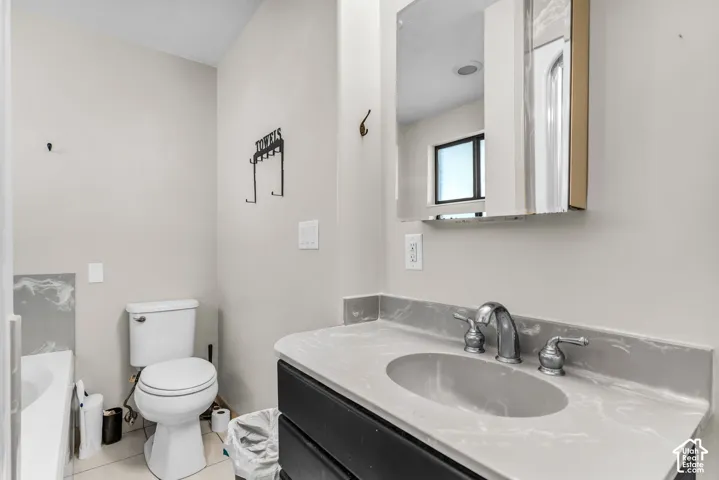 Vanity with an integrated sink, polished chrome faucet, and gray countertop