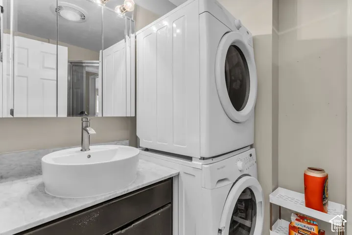 White vessel sink with a brushed nickel faucet, set on a stone-finish countertop