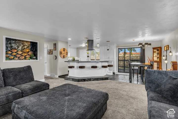 Open-concept living space with carpet flooring and light-toned walls